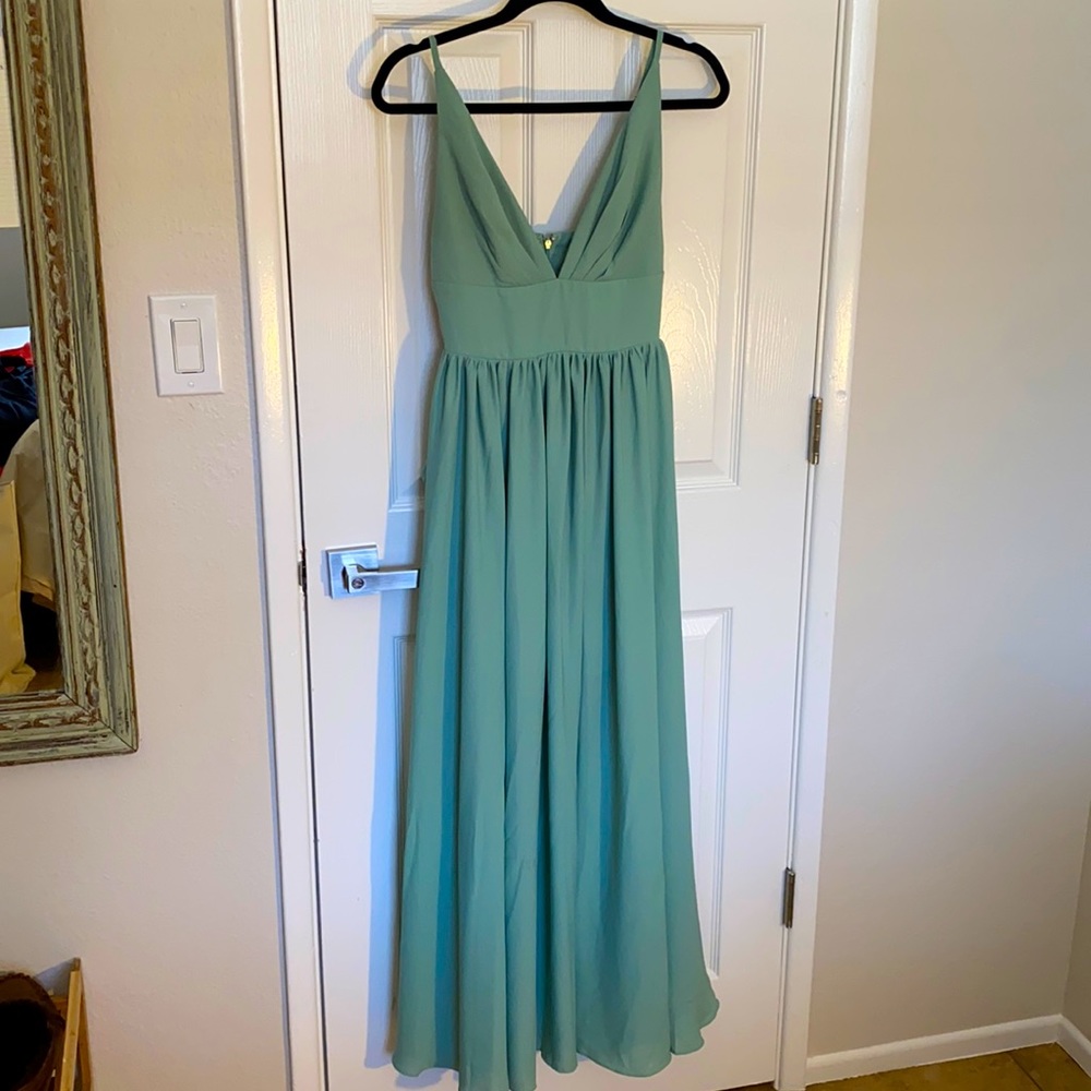 Sage, flowy Frame and Partners Stella dress with pockets.